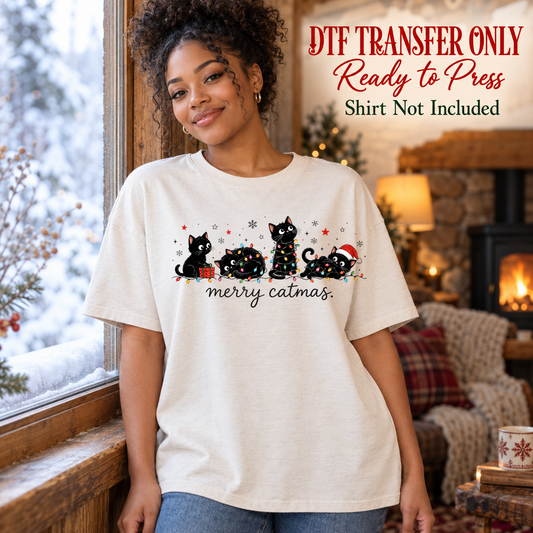 Funny Christmas Merry Catmas design shown on a cream shirt worn by a model; DTF transfer only, shirt not included.