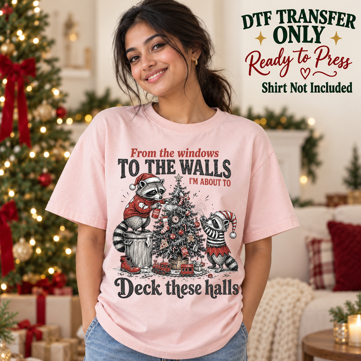 Funny Christmas Raccoon Deck These Halls design shown on a pink shirt worn by a model; DTF transfer only, shirt not included.