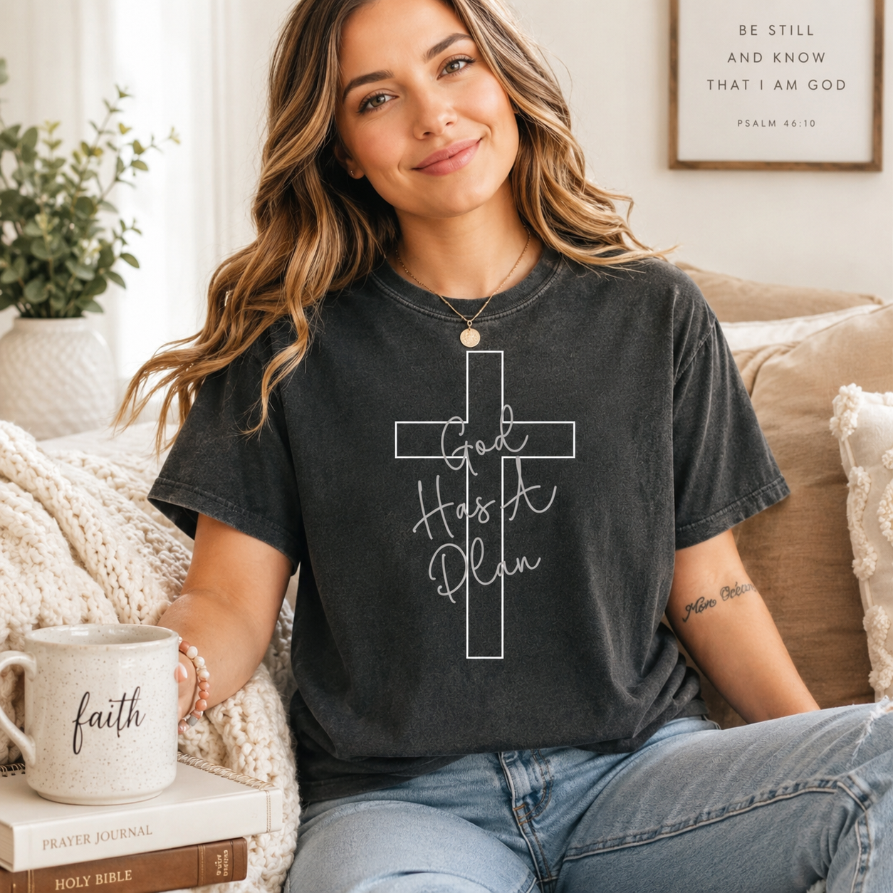 Black shirt mockup featuring a faith ready to press dtf transfer with a white cross outline and the phrase God Has A Plan in soft script lettering.