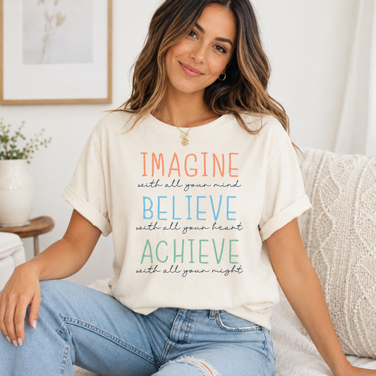 Cream shirt mockup featuring a motivational ready to press dtf transfer with the phrase Imagine Believe Achieve in soft pastel lettering.