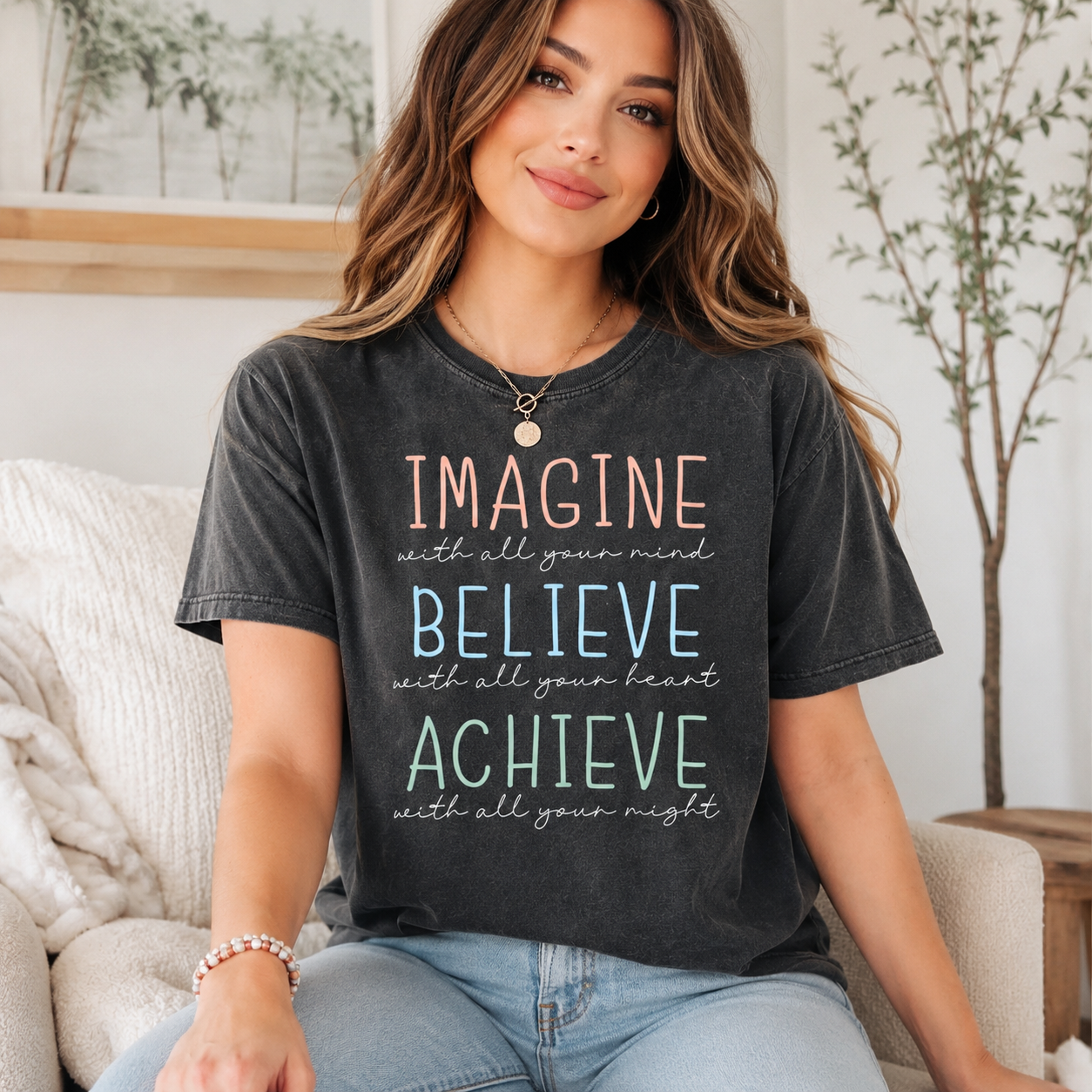 Woman wearing a black t-shirt with motivational quote in a home setting