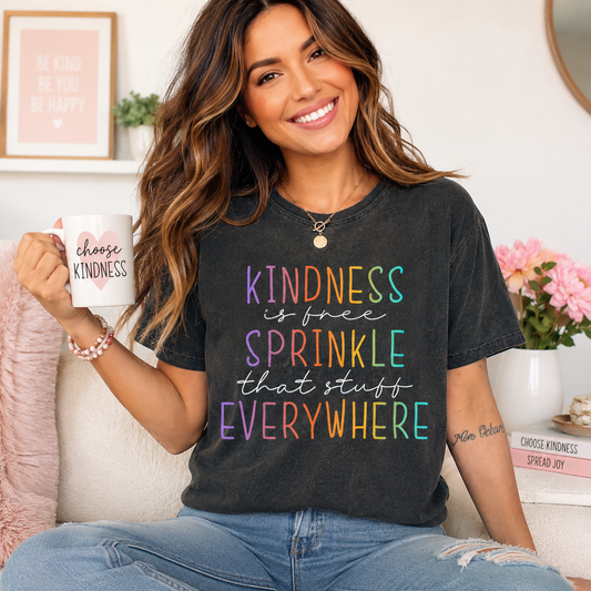 Black shirt mockup featuring a colorful kindness ready to press dtf transfer with the phrase Kindness is free Sprinkle that stuff Everywhere.