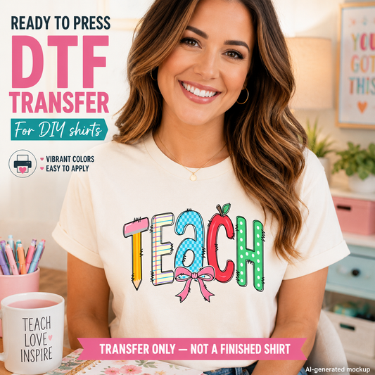 Woman wearing a 'TEACH' shirt with colorful design, sitting at a desk.